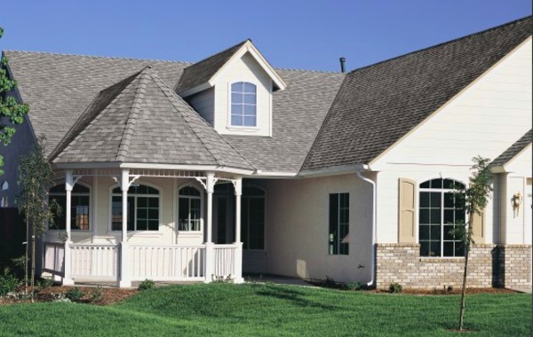 White home with a shingled roof and white gutters.
